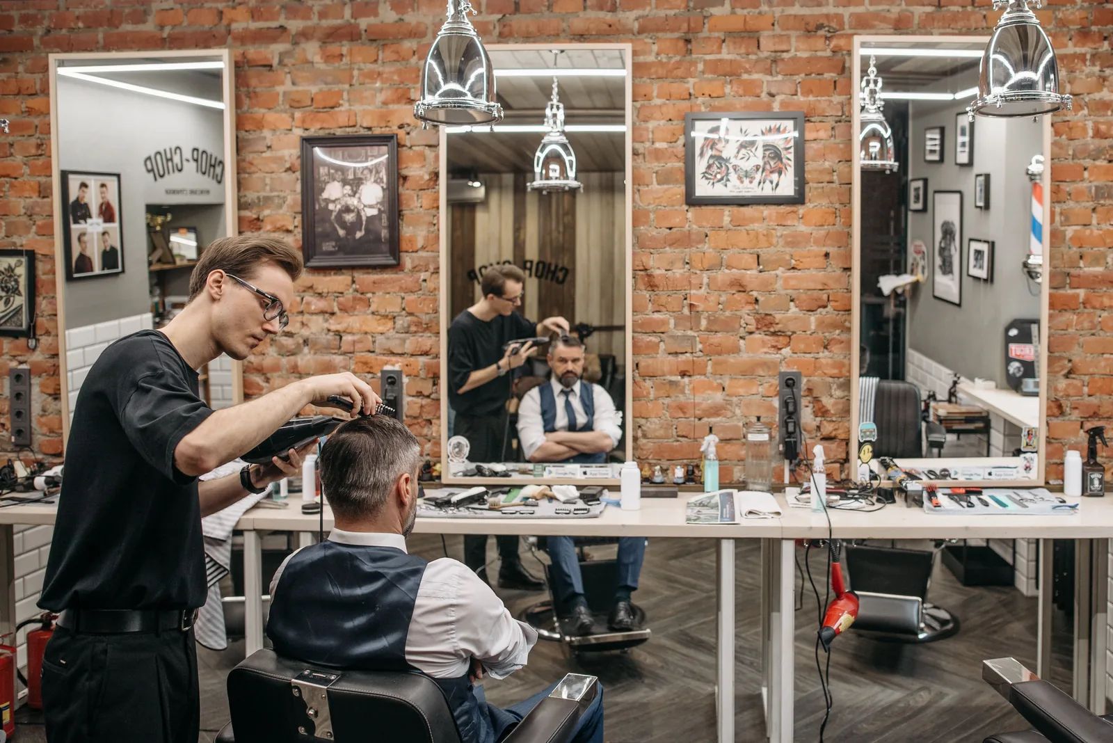 Professional barber giving a client a haircut in a modern salon